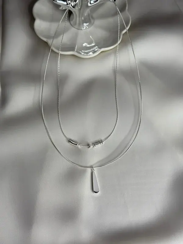Cristal — Doble hilo transparente con gota colgante.